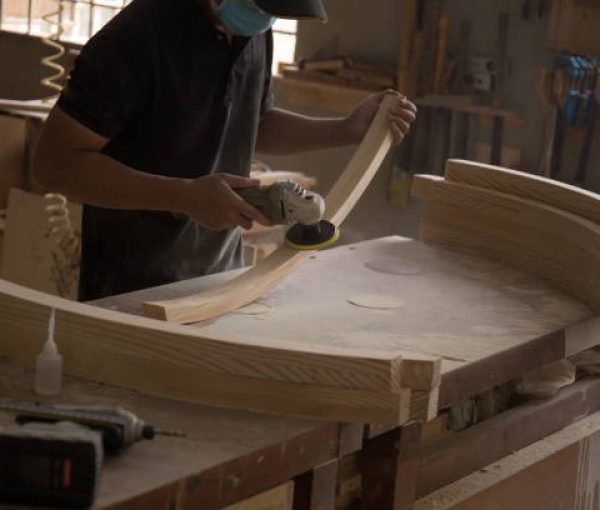 Photo of a young capenter doing his work in the workshop Photo of a young capenter doing his work in the workshop